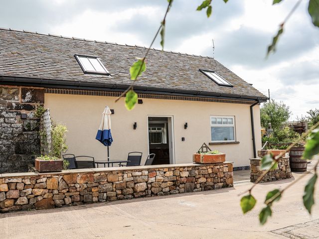 An outdoor area with a table and chairs at Fern Cottage in Biddulph
