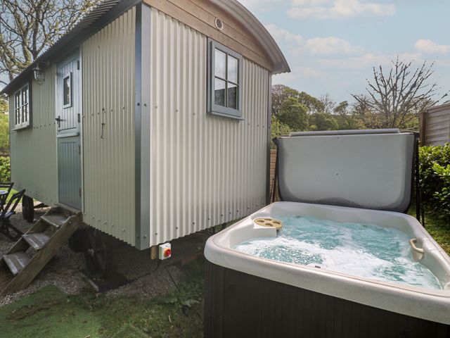 A shepherd's hut near a hot tub at Godrevy Shepherds Hut in Angarrack near Hayle