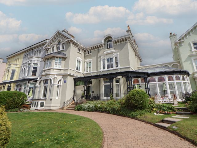 A large building with multiple windows and a curved pathway in front at Ismay Billiard Room Apartment - Titanic Interest in Waterloo Merseyside