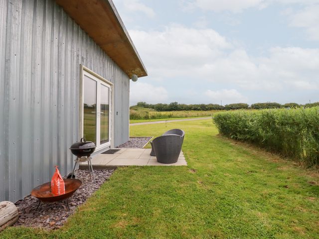An outdoor area with chairs and a grill at The Tinystore in Bodmin