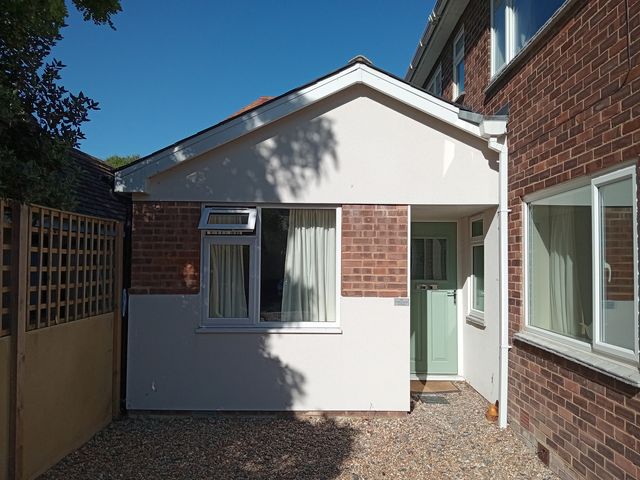 An exterior view of a house with a front door and windows at The Garden House Cottage in Whitstable
