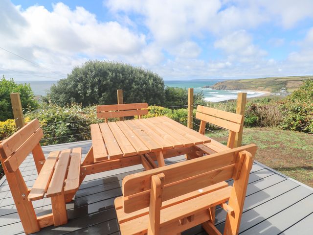 A wooden table and benches overlooking the ocean at Shearwater 