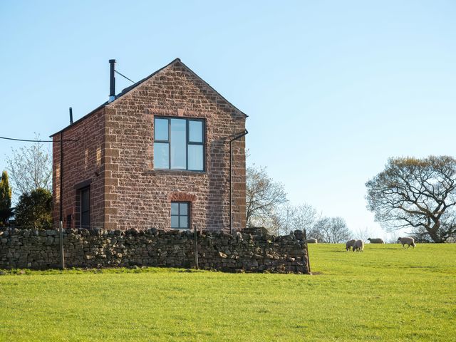 A house with a stone wall and sheep in the field at Shepherds View in Dufton, near Appleby-in-Westmorland