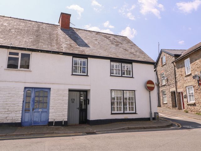A house with a blue door and a road sign at 19 Lion Street Hay-On-Wye