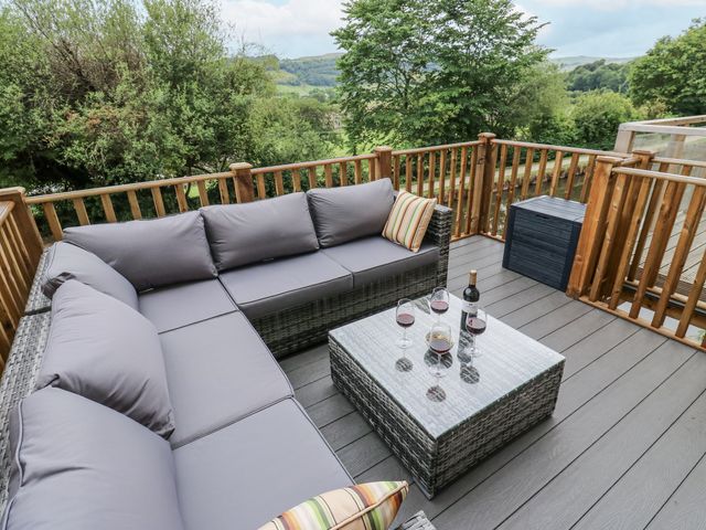 An outdoor living area with a sofa and table at Millside View