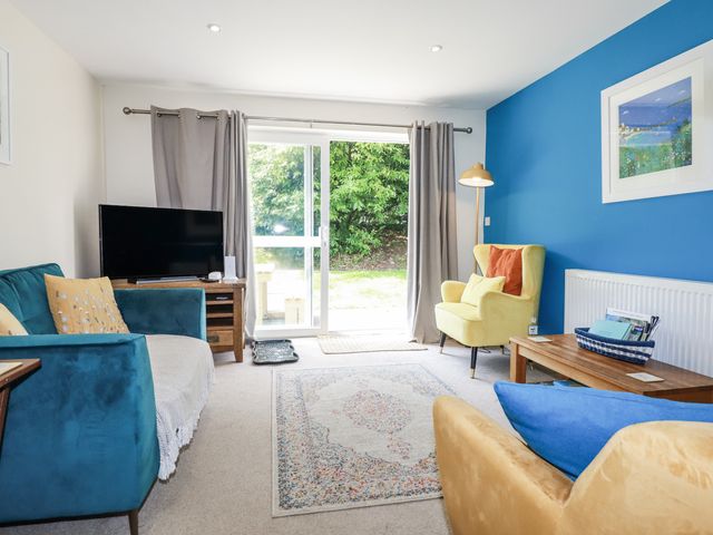 A living room with a tv and a sofa at 64 St Columb Road
