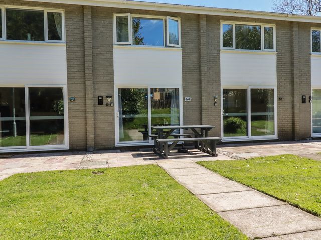An outdoor area with buildings and a picnic table at 64 St Columb Nr Newquay