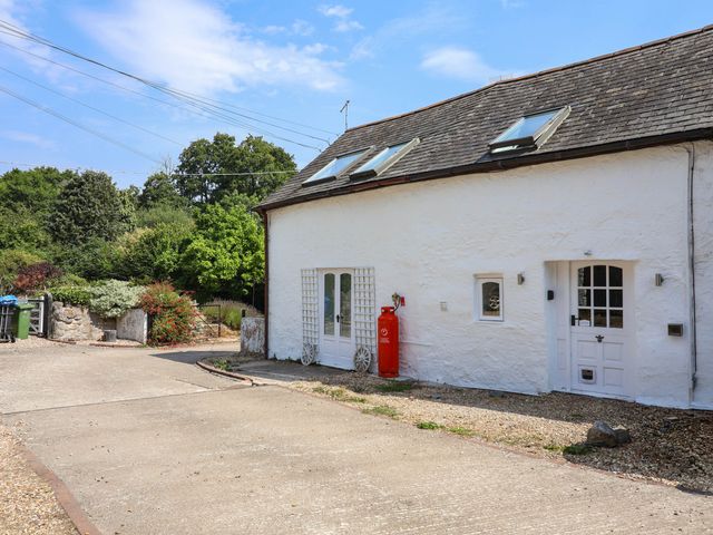 An outdoor area with a house and a gravel path at The Studio Cottage near Denbigh