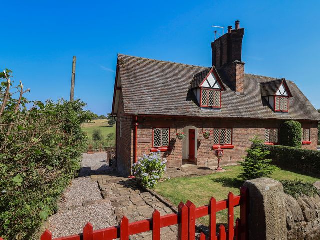 A house with a garden and pathway at 1 Fountain Cottages in Peckforton, Tarporley