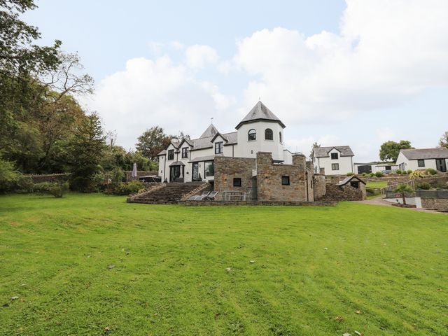 A large house with stone steps and lawn surrounded by trees at Glamorgan House in Cardiff