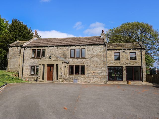 A house with multiple windows and a driveway at Stagwood House in New Mill