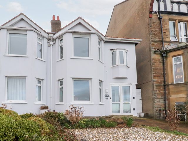 A house exterior with windows and a door at 480 Marine Road East in Morecambe