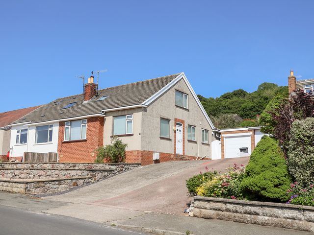 A house with a garage and garden at Bryn Bach in Rhos-On-Sea