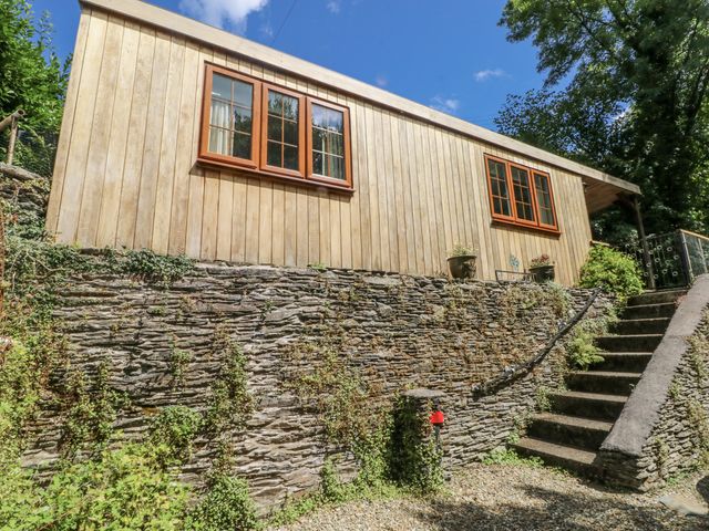 A wooden cabin with stone wall and steps at Ty Barddu Cwmorgan near Newcastle Emlyn
