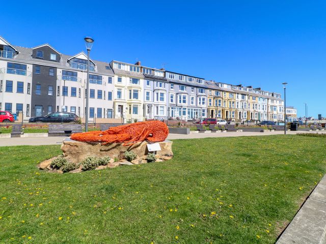 An outdoor area with a sculpture of a lobster and buildings in the background at Apt 6 @ Hunter's Quay, Bridlington