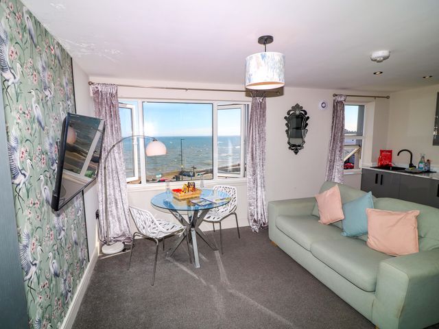 A living room with a sofa and a dining table at Apt 7 @ Hunter's Quay in Bridlington