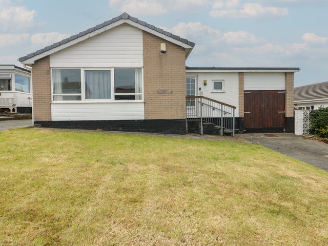 A house with a ramp and garage at 6 Gwelfor Estate