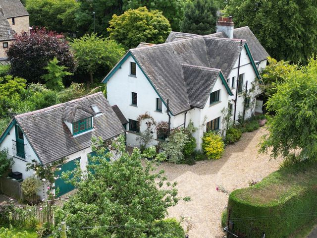 An exterior view of a house with a garage and garden at White House 