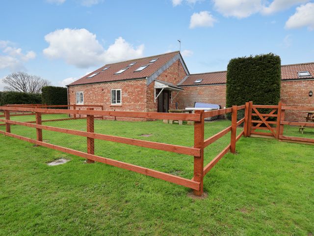 A fenced outdoor area with a house and gate at Kittiwake Flamborough