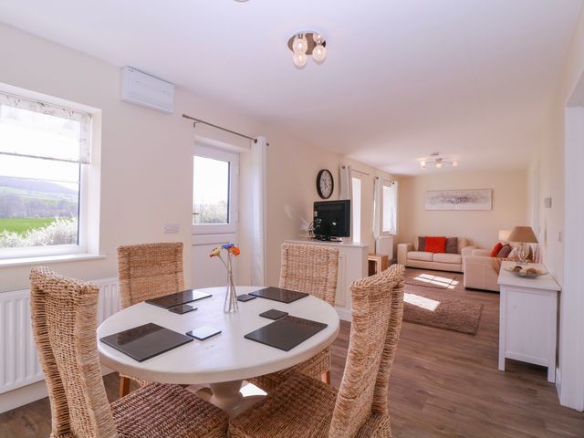 A dining room with a table and chairs at Country Cottage Brecon