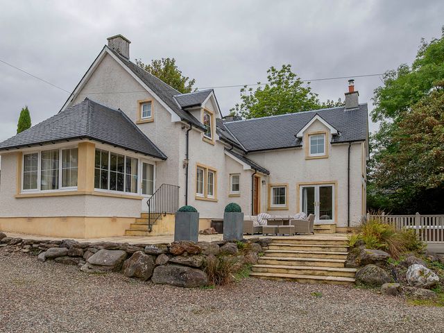 An exterior view of a house with steps and a patio at Taighean Anndra in Killin