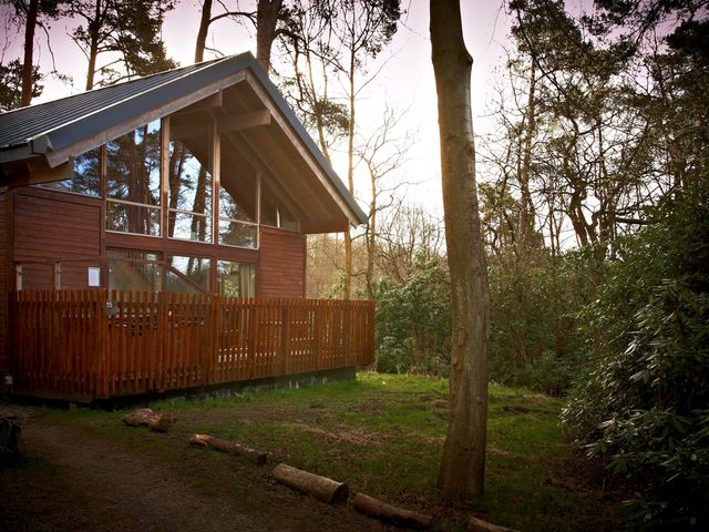 An outdoor area with a wooden cabin and deck at Strathyre Classic Silver Birch Strathyre, Ben Ledi