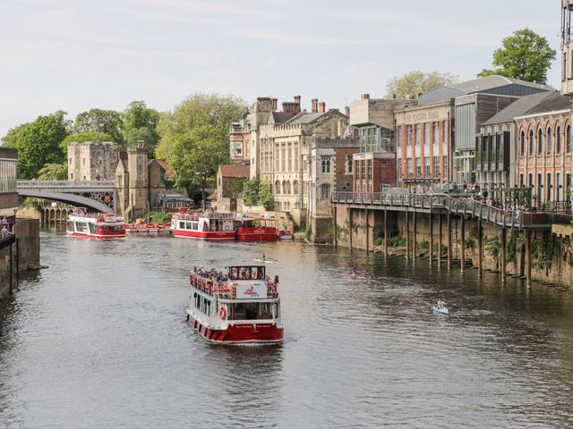 A river with boats and buildings along the bank at Deer Hill Grove in York