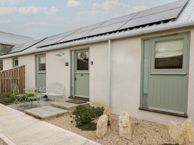 An outdoor area with a door and table at The Little Loft in Burford