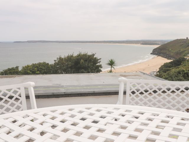 A view of the ocean and beach from a terrace at Flat 2, Moonrakers in St. Ives