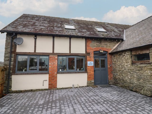 A building exterior with windows and a door at The Granary in Welshpool