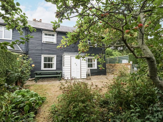 A house with a garden and bench at Chenies, Osmington Mills, near Preston