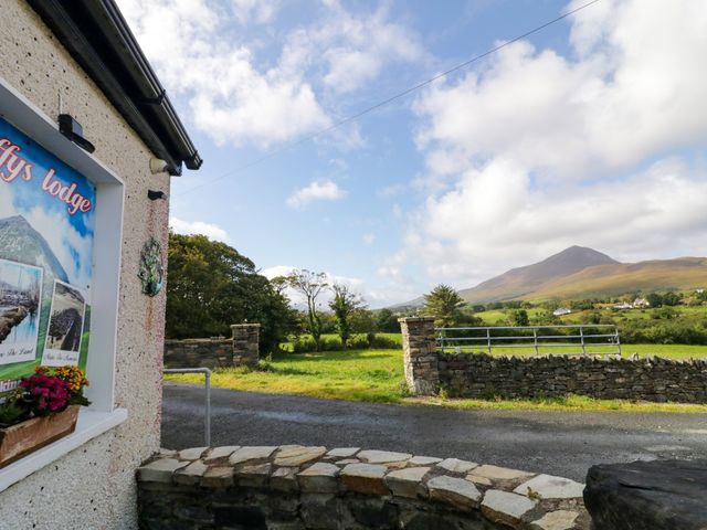 The exterior view featuring a sign and mountains at Duffy Lodge in Kilmacloo near Creeslough, County Donegal