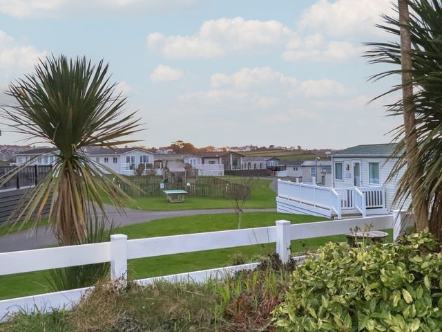 A holiday park with white fences green lawns and static caravans at Seaviews in Nefyn