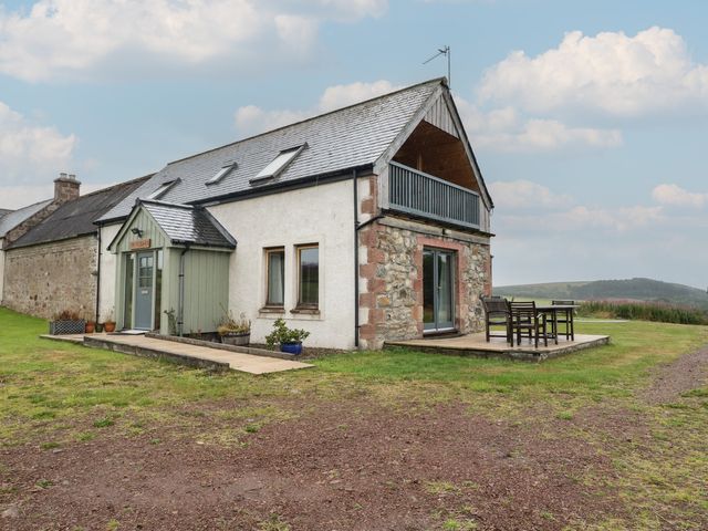 A house with a deck and furniture at Taffs Barn Fortrose near Rosemarkie