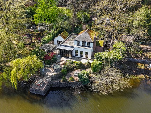 An outdoor area with a house near water at Lady Of The Lake Rudyard Lake