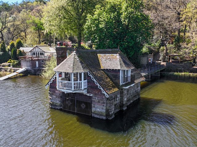 A house on the water with a bridge at Lady Of The Lake Rudyard Lake