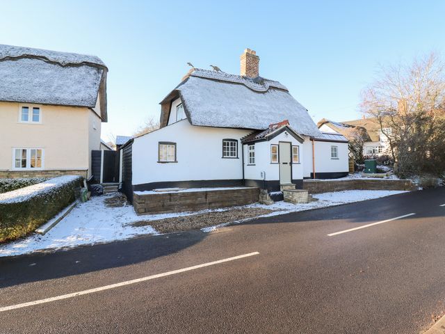 A thatched roof house with a driveway at 66 High Street in Cambridge