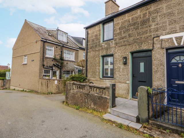 Two houses with steps and a gate at East meets West Criccieth