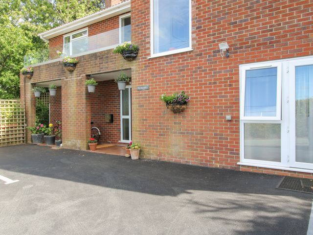 An exterior view showing a building entrance with flower pots at Plum Hill in Morda, near Oswestry