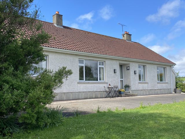 A house with windows and a door at Betty's Farm Cottage Lack near Ederney, County Fermanagh