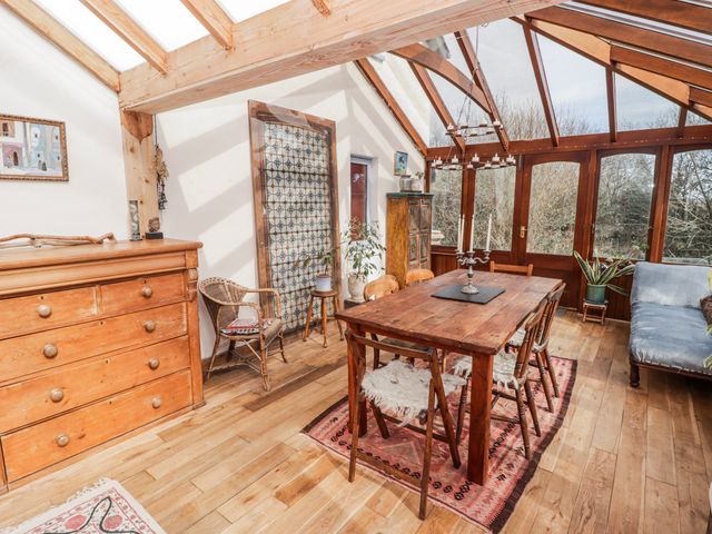 A dining area with a table and chairs at Pencestyll in Cardigan
