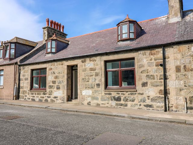 A stone house with windows and a front door at No.9 North St Fraserborough