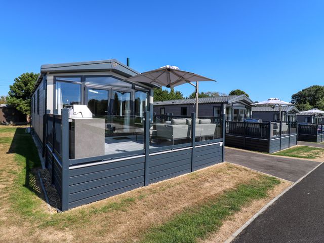 A holiday home with decking and outdoor furniture at Lakewood Plot 2 St. Osyth