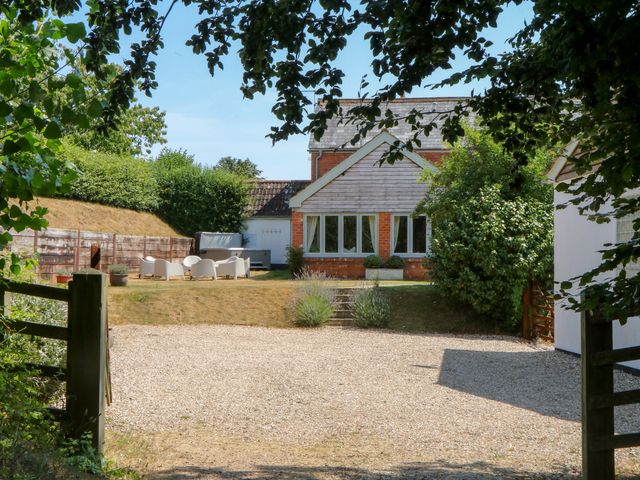 An outdoor area with a house and seating at Apple Mill in Venn Ottery near Sidmouth
