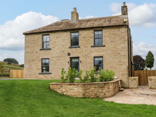 A house with windows and a front door surrounded by grass at Eastfield Farm in Barnard Castle