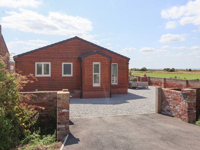 A house with gravel driveway and furniture at Waverley Cottage Kilnsea near Easington, Hull
