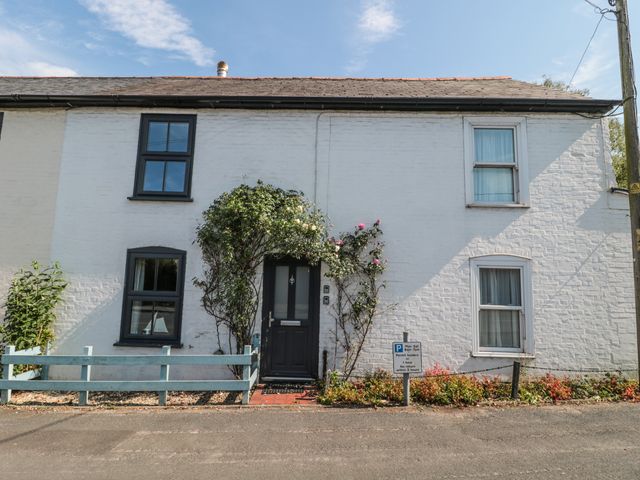A house with flowers and parking sign at Stones Throw in Lymington