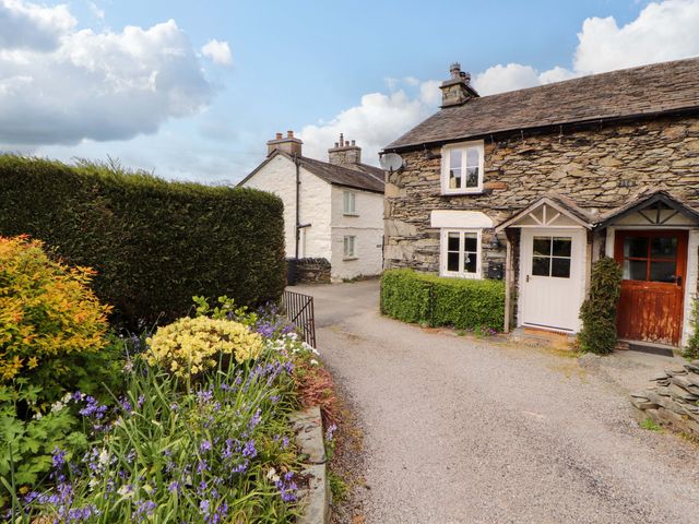 A house with a flower bed and pathway at Byways Ambleside