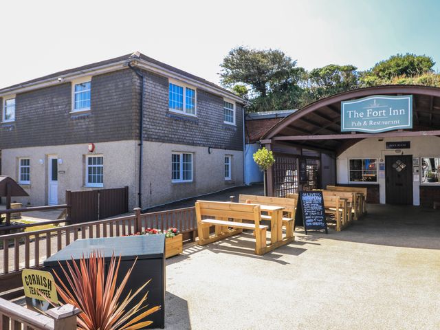 An outdoor seating area with benches at The Fort Inn in Torpoint