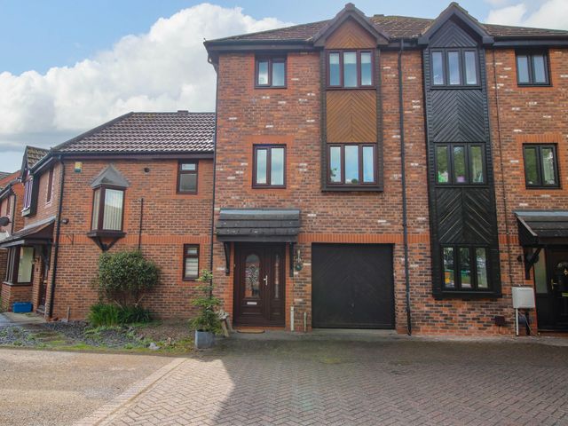 A brick townhouse with multiple windows a driveway a garage and a front door at 63 Severn Street Bridgnorth